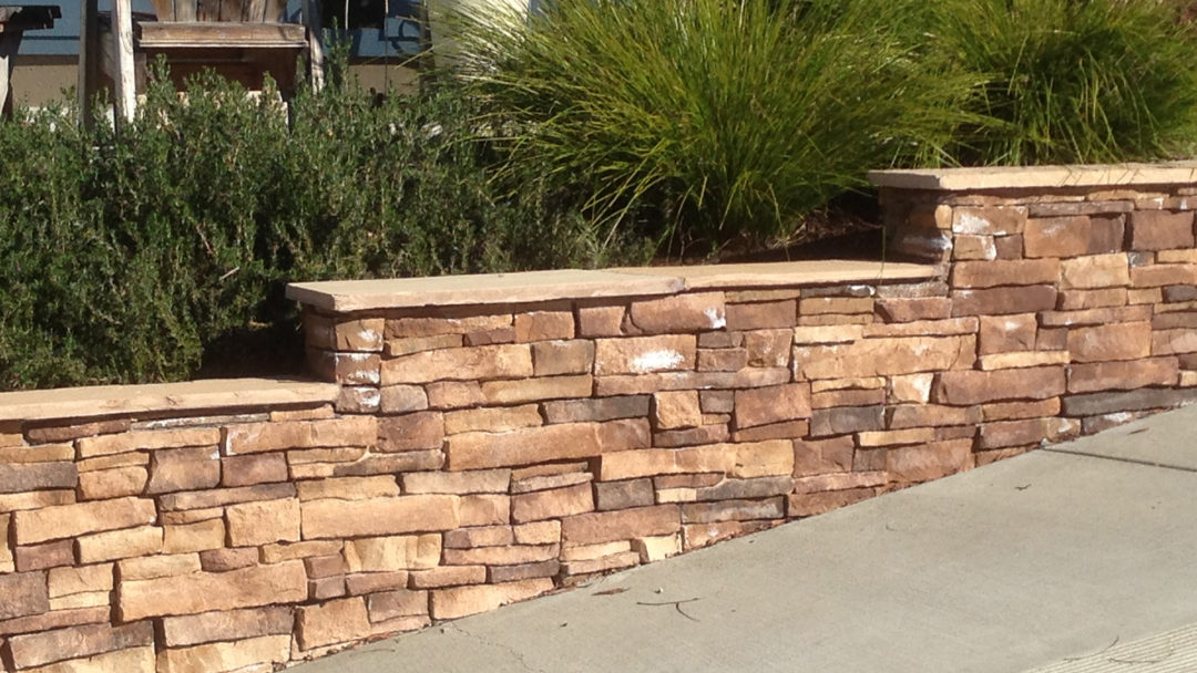 Cultured stone stepped wall with flagstone cap - Details Landscape Art