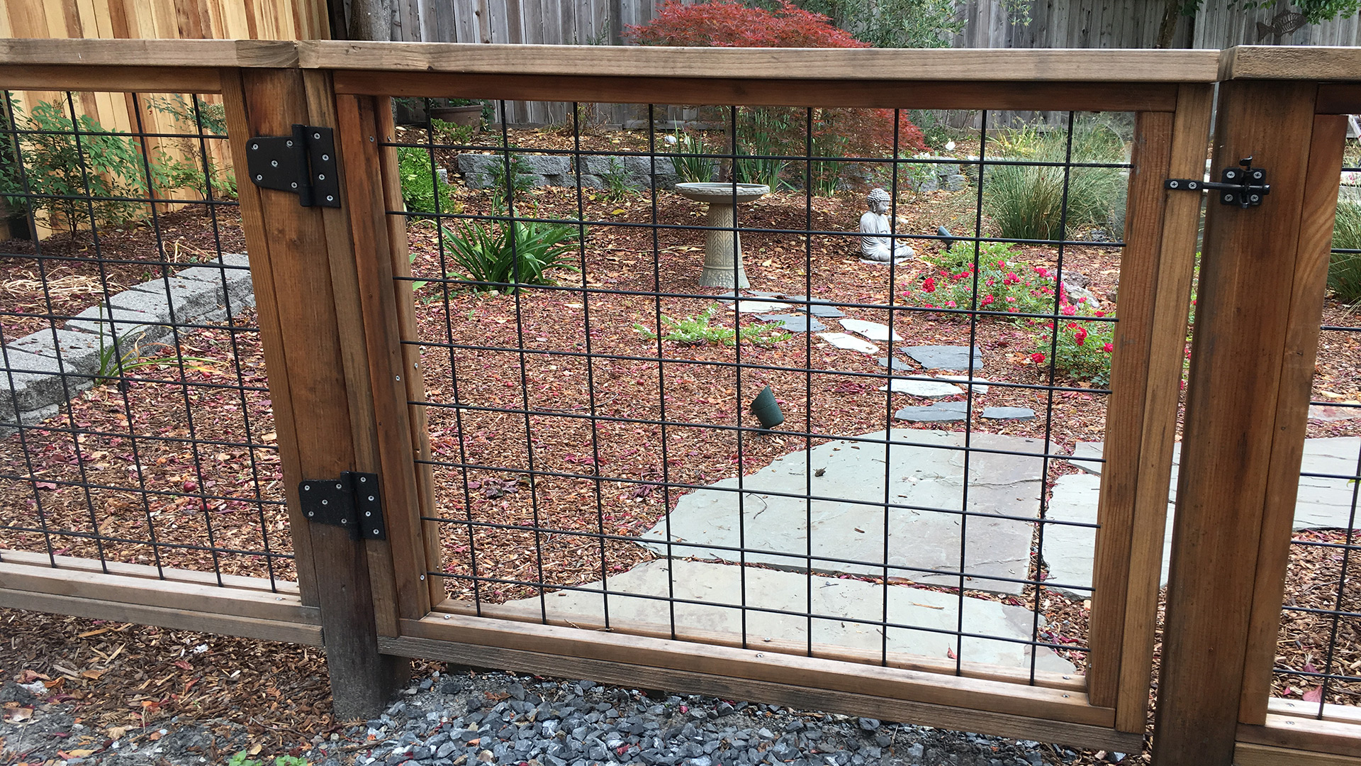Black hogwire fence framed in redwood